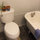 Toilet and clawfoot tub and shower