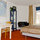 On the left the kitchen table with chairs. In the middle the vitrine with TV
