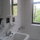 Clean, bright bathroom includes full size tub and plenty of light.