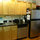 Kitchen with cabinets, dishwasher and big fridge and freezer.