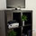 Entertainment center includes flat screen TV, DVD player with gaming console.