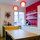 kitchen appliences include fridge, dishwasher (both behind white interior), sodastream, kettle, blender, microwave and toaster..