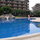 Super-large children's pool with waterslide and playground in background...