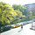 View over green community garden and down Avenue C from beroom.