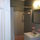 Bathroom features massage shower, dual flush toilets and reclaimed knotty pine ceiling.