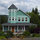 Front of house and garden in summer.
