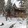 back of house with sled run in foreground