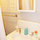 Bathroom with medicine cabinet stocked with toiletries