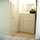 Changing room/closet with dresser and vanity mirror. Doors close for privacy.