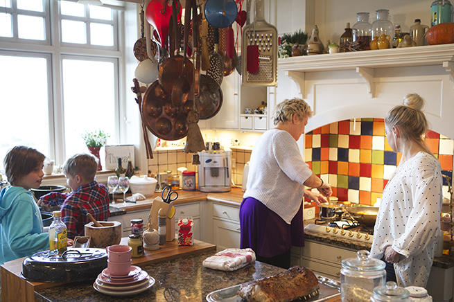 Her colorful, fully equipped kitchen provides the perfect backdrop for lively conversation with friends and family.