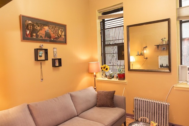 Their classic NYC living room, taxi-cab yellow, fire escape gate and all.