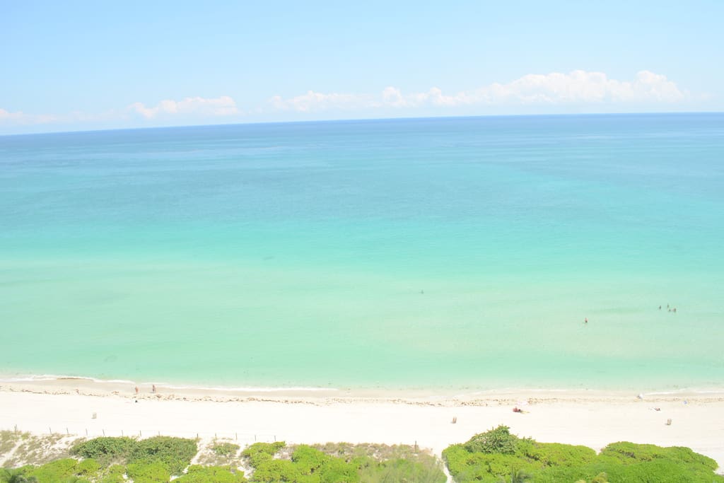 white sand beach view from window of apartment