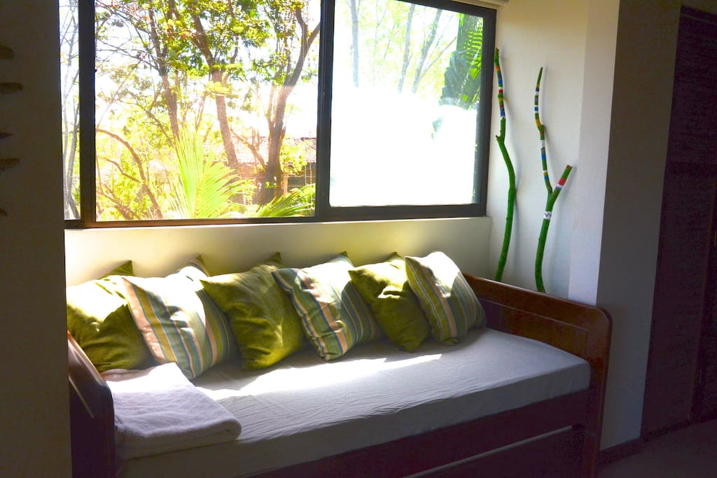 Also in the living room the sofa-bed has views toward the gardens.