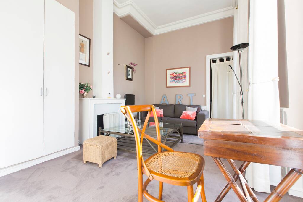 The living room, very bright with 4 big double windows !