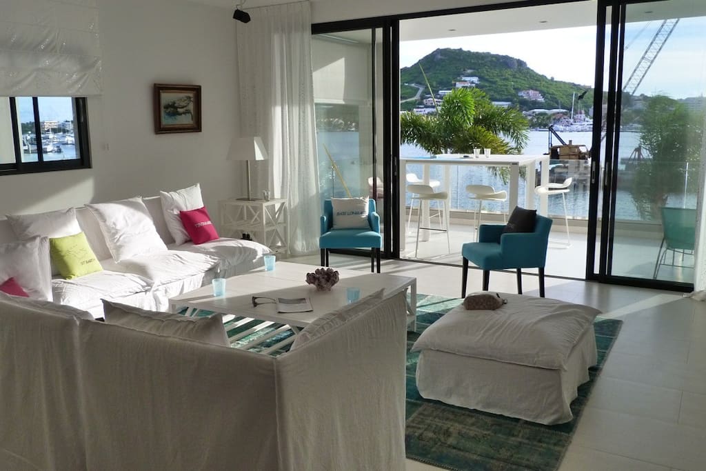 Living room area with a flat screen TV and view of the lagoon and sea