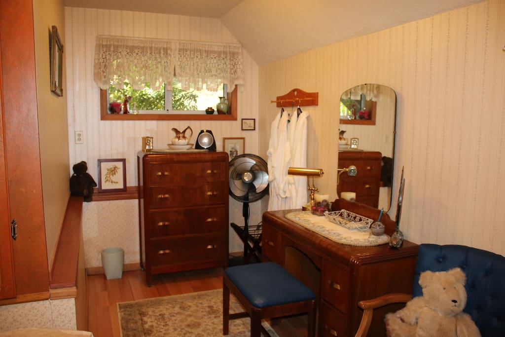 The other part of your bedroom has a dresser and small desk. There are fluffy white robes for your use.