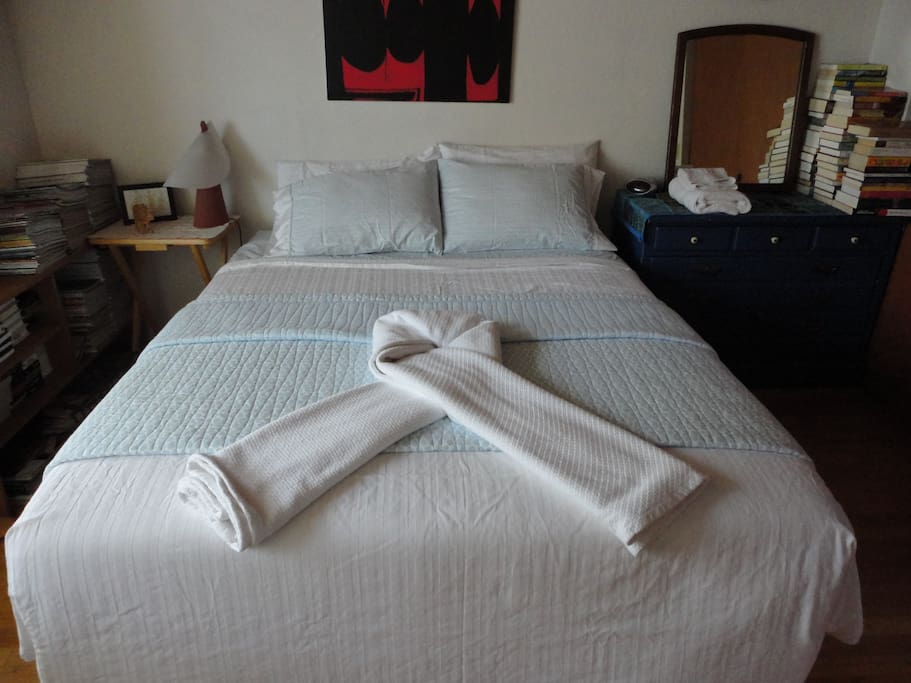 A queen size bed with fresh clean linens