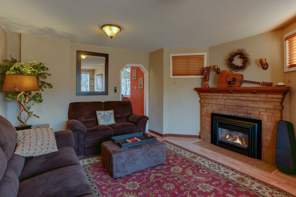 Large living room for relaxing. Gas insert fireplace adds warmth and character.